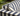 A close-up view of a blue and white striped outdoor sofa. Text reads: SolarWeave™ UV and fade resistant.
